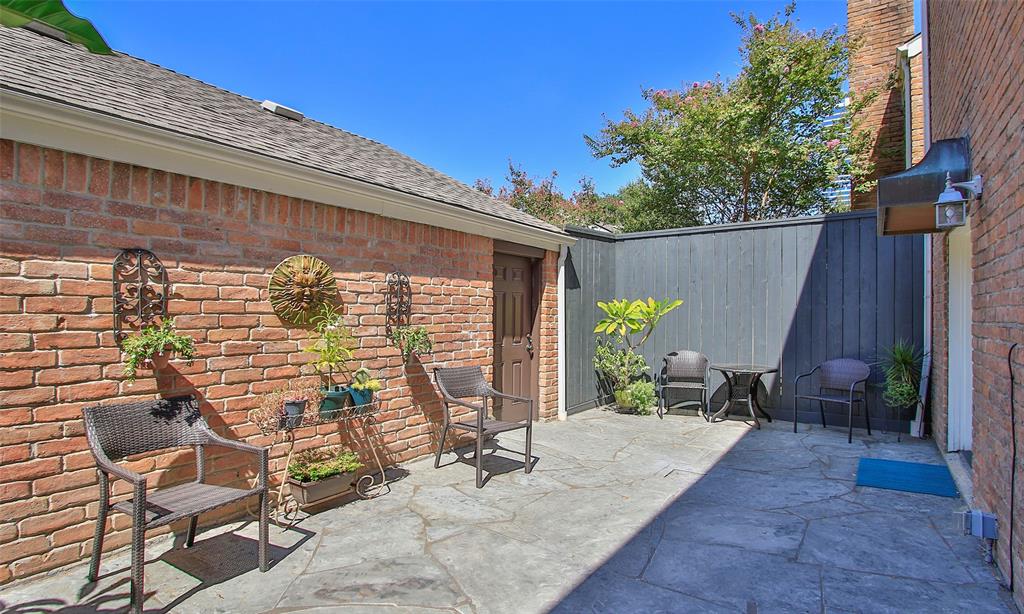 The patio is situated between the townhome and double car garage.