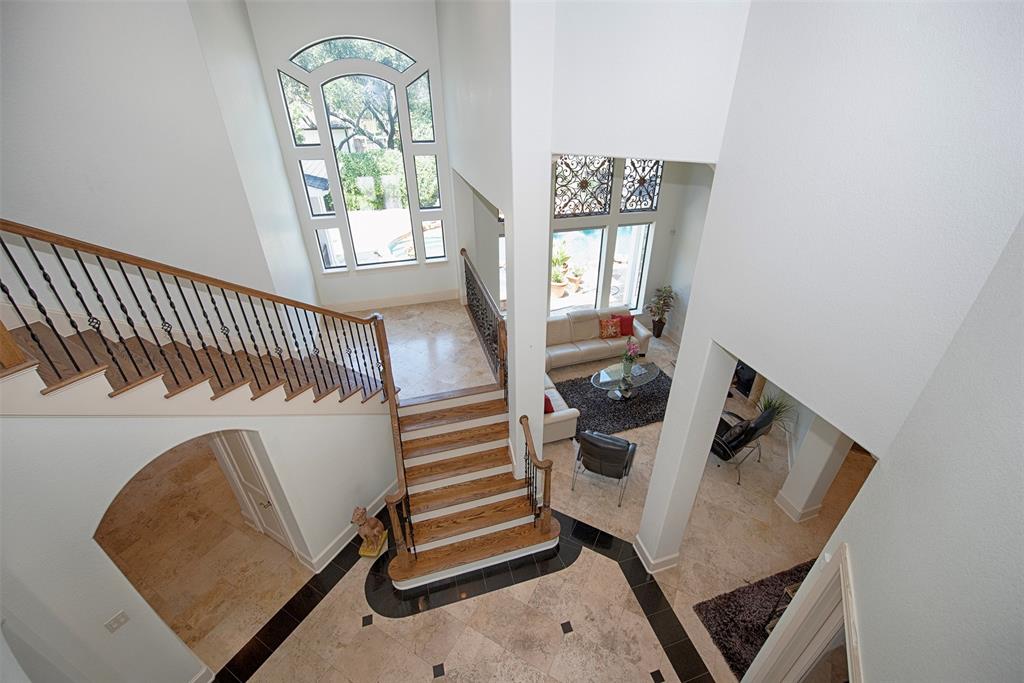 The grand staircase from the foyer leads to 3 bedrooms (1 with ensuite) and a game room upstairs.