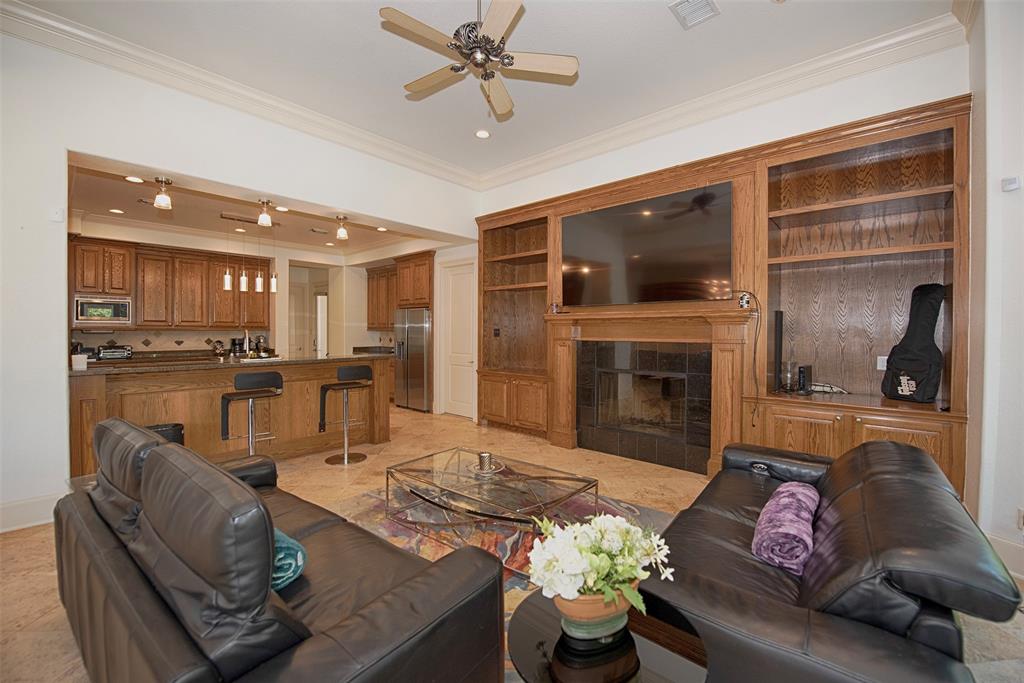 Built-ins around the fireplace and excellent views of the outside are features of this family room.
