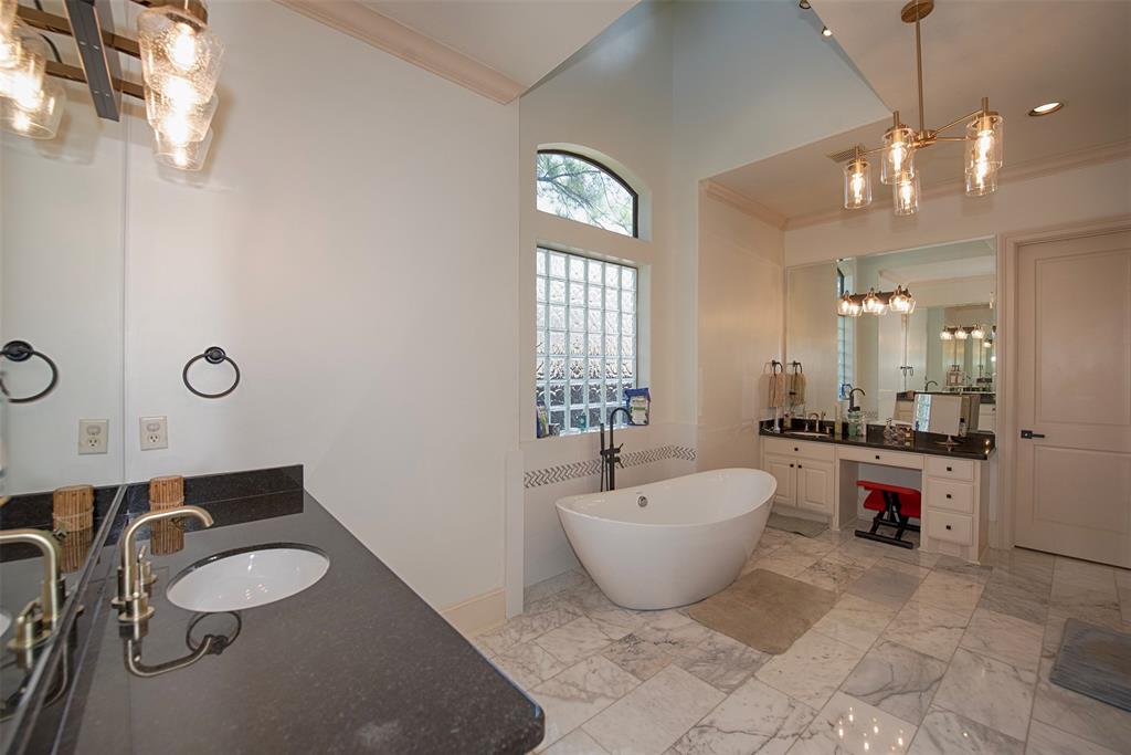 The ensuite bath is a spa retreat with marble floors, separate granite vanities, freestanding tub and abundant lighting.