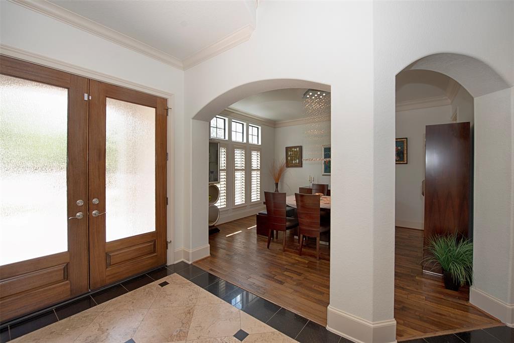 From the foyer, arched entry ways lead to the formal dining room.