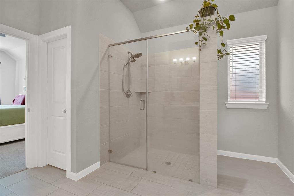 Another view of the primary bathroom showcasing a large walkin shower