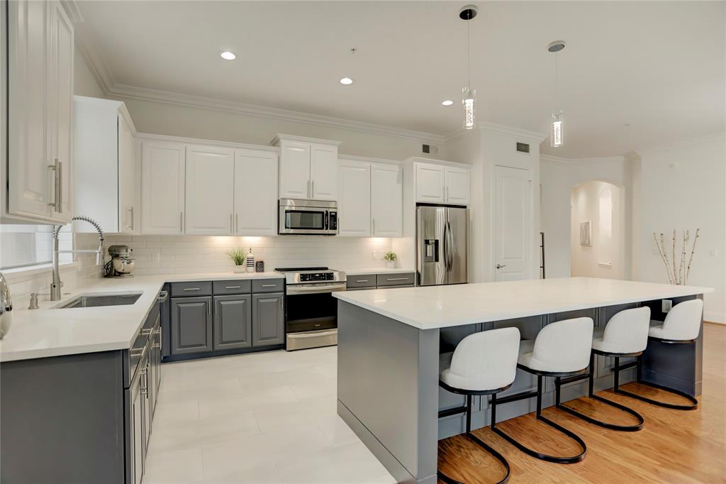 The pendant lighting above the island along with the recessed lighting make this kitchen truly feel like a dream come true.