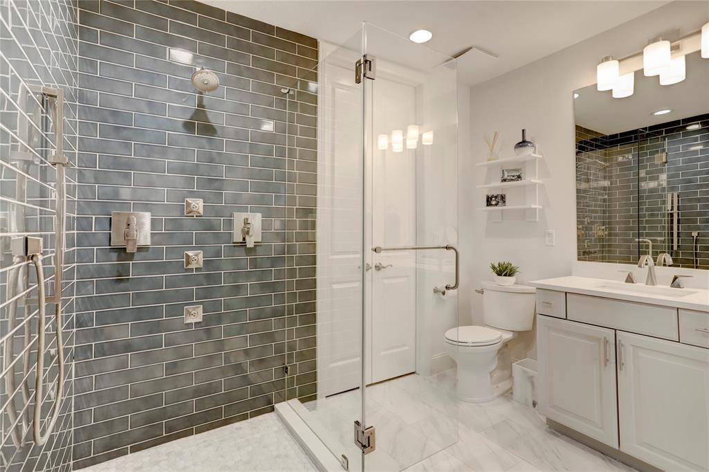 Ensuite bathroom features large walk-in shower, large vanity and ample storage.