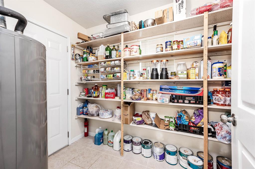 ADDITIONAL PANTRY/STORAGE ROOM IS LOCATED NEXT TO BREAKFAST AREA. THIS WAS THE FORMER UTILITY ROOM AND ALL CONNECTIONS (GAS & ELECTRIC FOR DRYER AND WATER HOOKUPS FOR WASHER) ARE STILL IN PLACE.