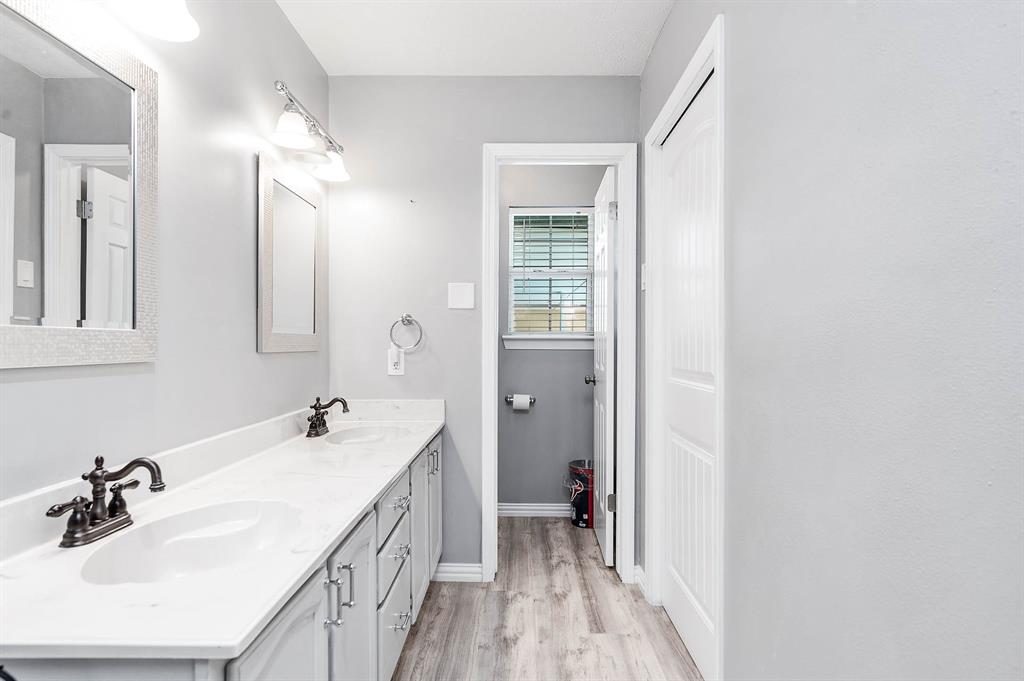 PRIMARY BATH HAS 2 SINKS AND A GLASS SHOWER.  A LARGE WALK-IN CLOSET COMPLETES THE PRIMARY BEDROOM.