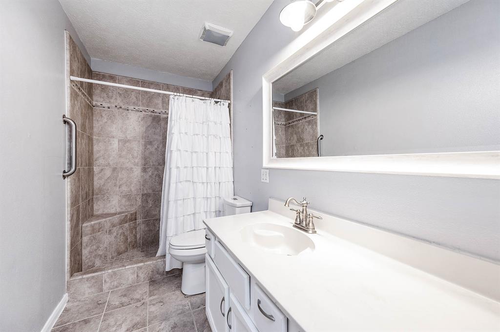 HALLWAY BATHROOM IS LOCATED ON FIRST FLOOR AND HAS A WALK-IN SHOWER AND A LINEN CLOSET.