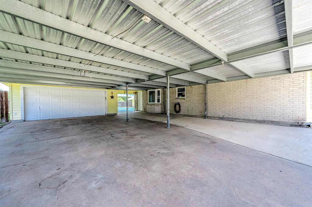 COVERED CARPORT OFFERS PARKING FOR AT LEAST 6 CARS. 8\' ROLL DOWN DOOR CLOSES OFF THE POOL AREA & BACK YARD.  ONLY OPENS THROUGH THE INSIDE OF BACK YARD.