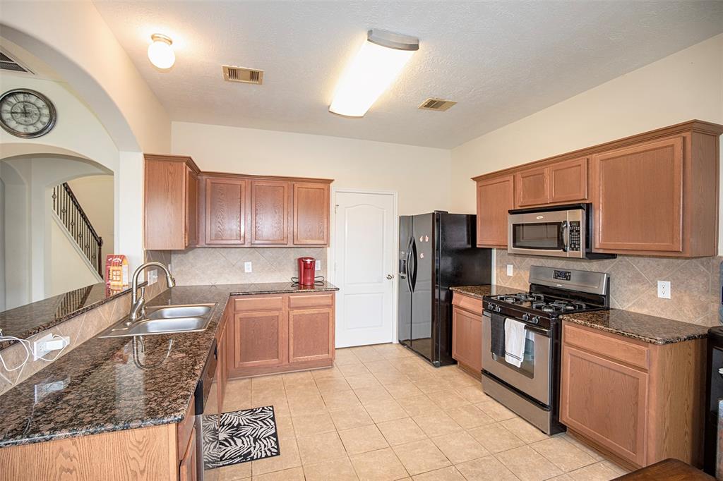 The kitchen features beautiful granite counters and ample cabinet space.