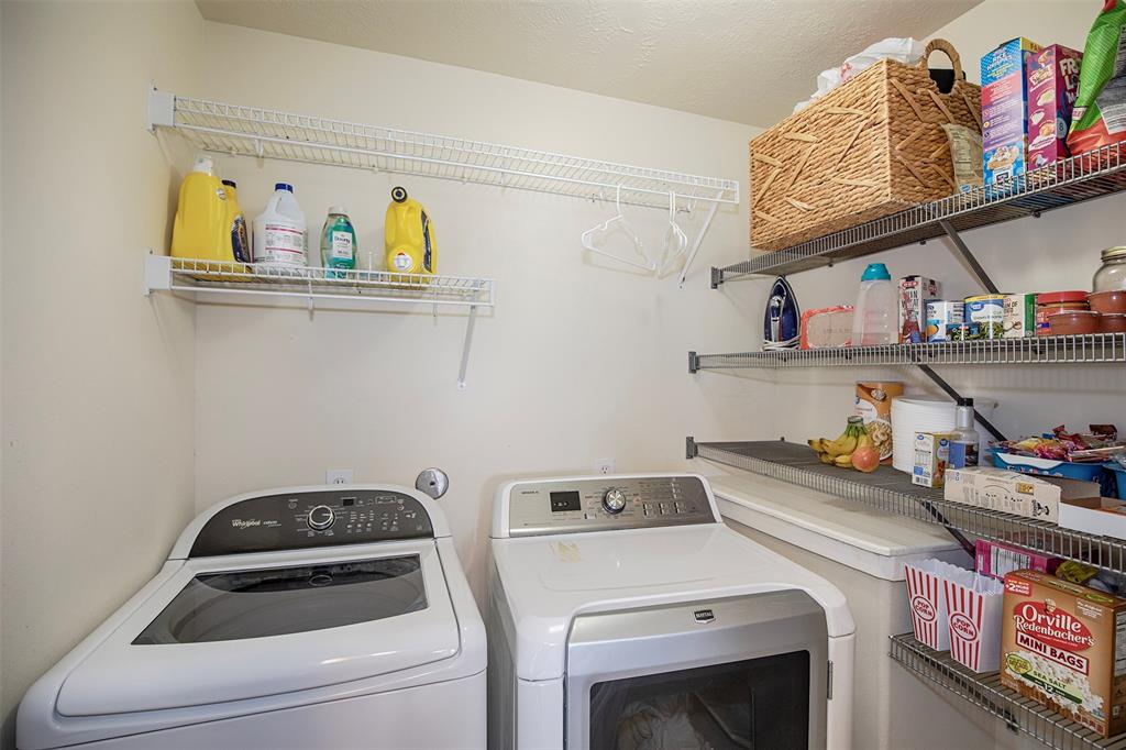 In the kitchen, you will find the utility room with shelving for pantry items.