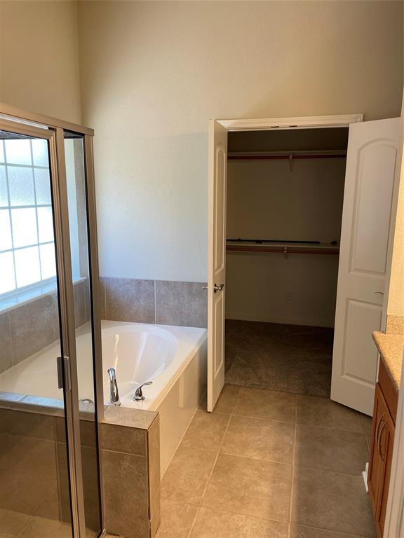 Master bath with separate tub and shower, large walk in closet