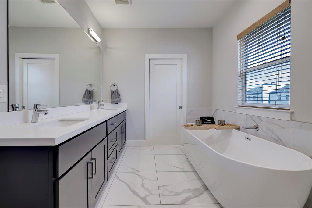 Primary bathroom features dual vanity sinks and soaking tub!