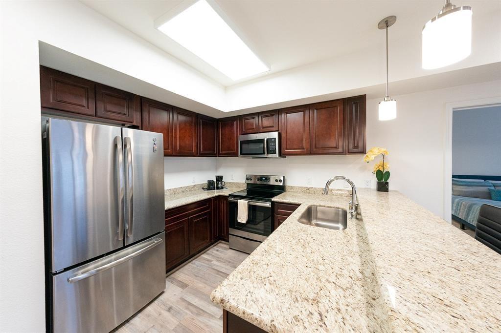 A fully furnished kitchen with all the essential appliances and amenities.
