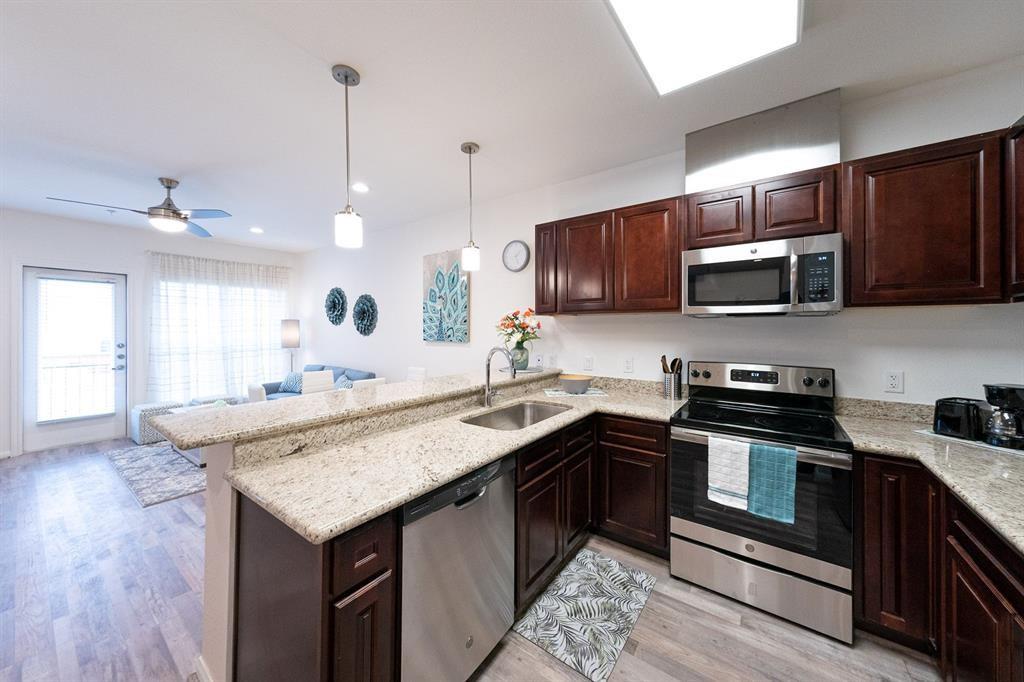 Full kitchen has a stainless steel appliances and French door refrigerator. Also notice the built in microwave so no counter space is wasted, the granite countertop as well as the Electric cooktop.