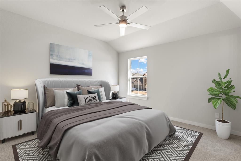 This secondary bedroom features high ceilings, lovely modern ceiling fan, custom paint, plush carpet, space for seating area, and a large window with privacy blinds!