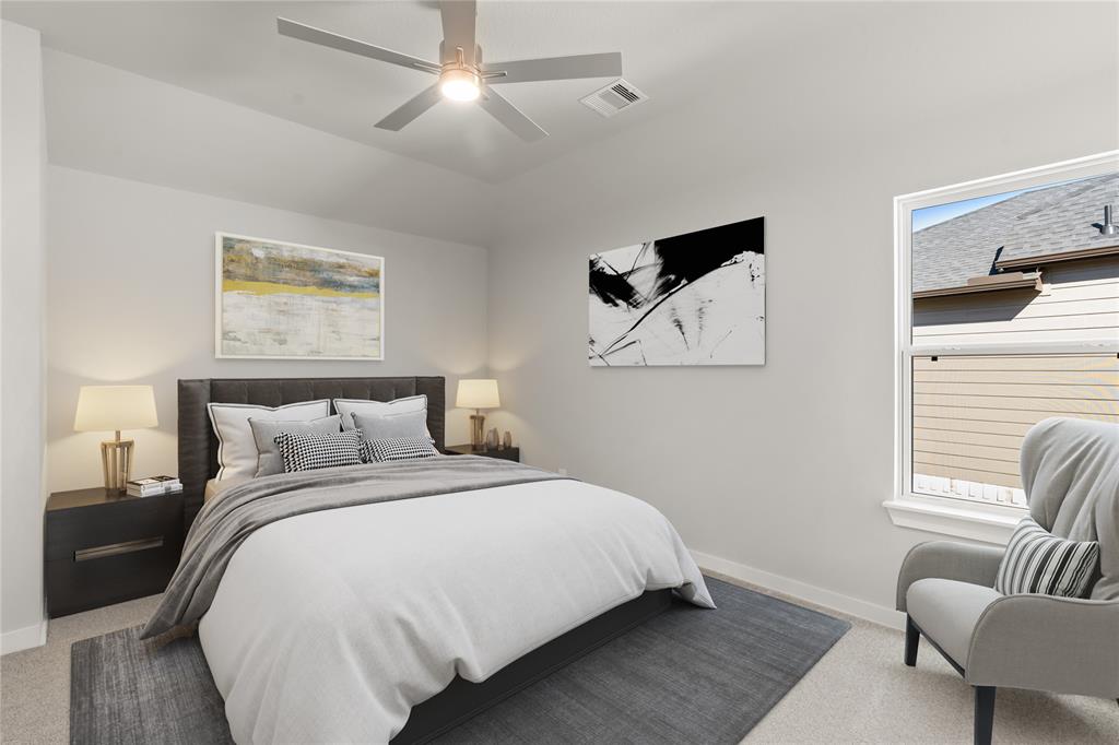 This secondary bedroom features high ceilings, lovely modern ceiling fan, custom paint, plush carpet, space for seating area, and a large window with privacy blinds!