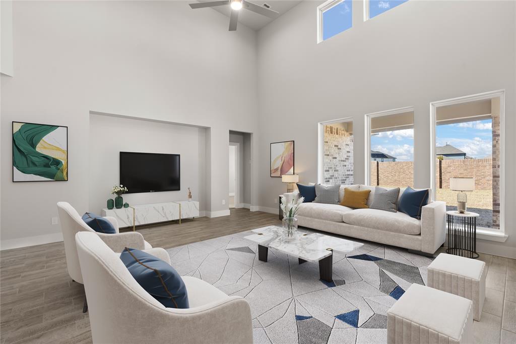 Gather the family and guests together in your lovely living room! Featuring soaring high ceilings, recessed lighting, ceiling fan, custom paint, gorgeous tile floors, and large windows that provide plenty of natural lighting throughout the day!