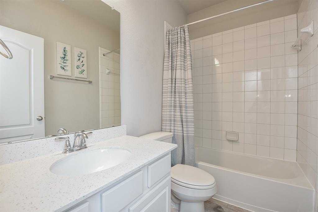 This modern and bright bathroom services the 2 secondary bedrooms at the front of this home