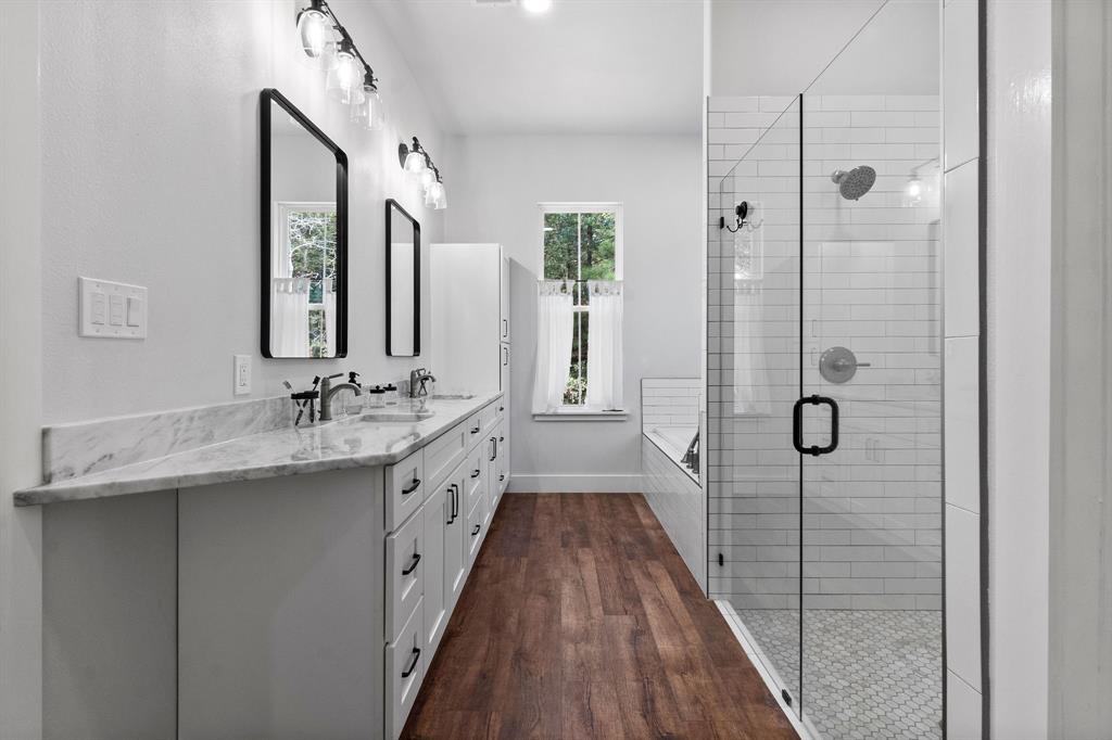 Talk about an exquisite en-suite with a soaking tub, spacious stand-up shower & double sinks with quartzite counters flowing from the kitchen.