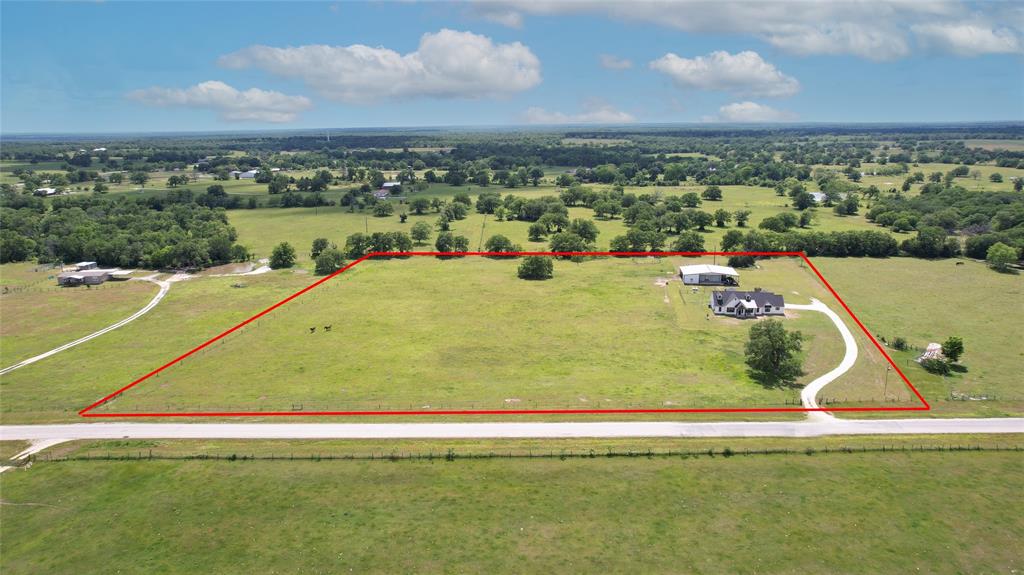This custom built home on 10 acres offers a luxurious living experience with functional floorplan & unique features. The house includes 4 bedrooms, 3 bathrooms, a study (or 5th bedroom) with a walk-in safe & a 1 bed 1 bath garage apartment in the steel barn workshop that has a hay storage, tack room & space for 3 stalls. The home is 2,768 sf & has no carpet, 8x10 fully ventilated fire-resistant walk-in safe, built-in surround sound in living room and on back porch, a mudroom with lockers, oversized laundry room & 8.5 x 7.5' pantry. Kitchen has granite, double oven, 5-burner stove & extended island. Living room features stained beams in the vaulted ceiling, floor to ceiling gas fireplace & ample natural light. The master bedroom is spacious & includes a master bath with separate vanities, garden tub, tiled shower, toilet closet & custom built shelving. The property is fully fenced with an entry gate & has an ag-exemption. Located only 17 miles from the University. AHS warranty included!