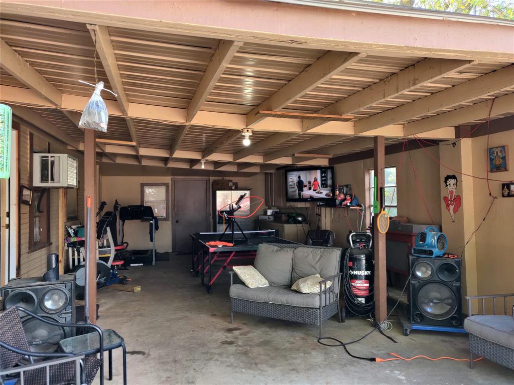 The garage is being used as a great gathering spot for friends to hang out.