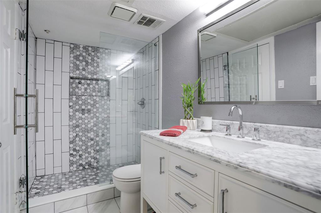 Beautiful bathroom with upgraded tile work in the glass enclosed shower and a luxe vanity with plenty of storage space!