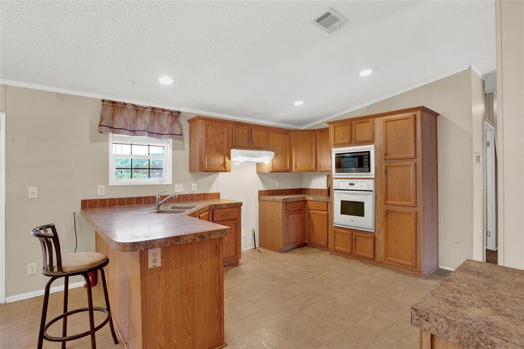 Kitchen with breakfast bar open to family room.