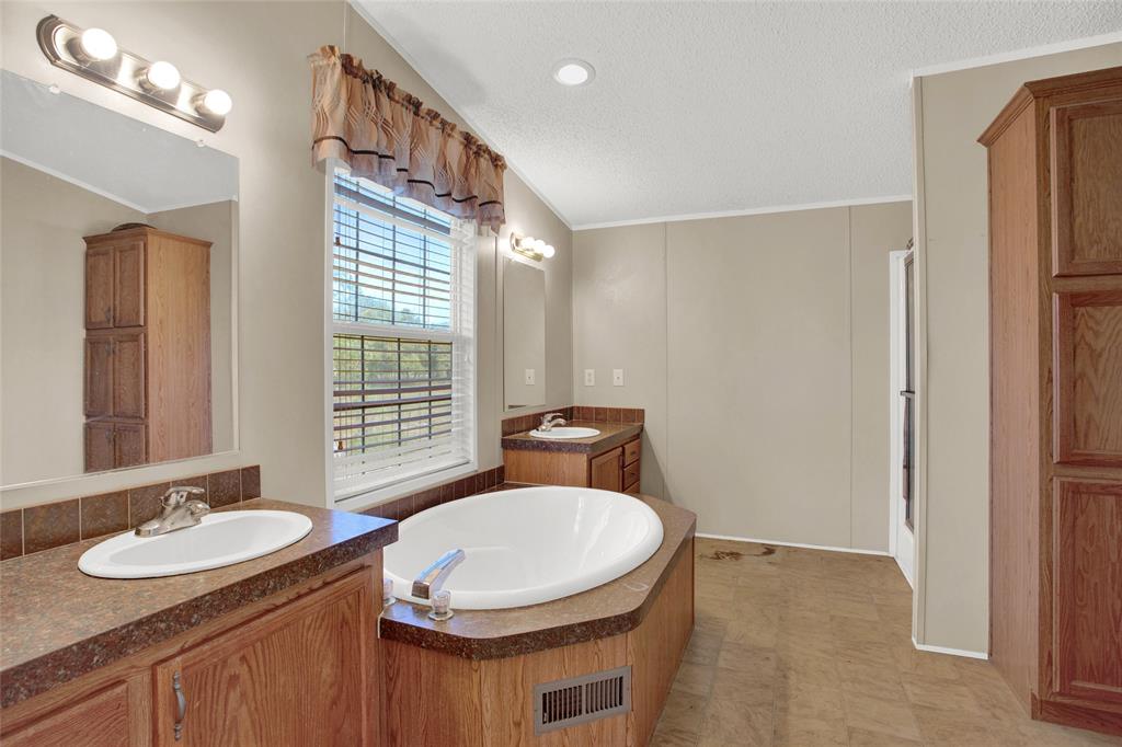 Primary bath with double sinks, soaking tub, separate walk-in shower and plenty of storage!