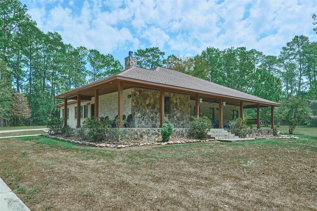 Gorgeous custom home in a true country setting.  This lovely home sits on 19 acres of wildlife exempt land w/a   large deep pond.  Ride a horse or ATV throughout the 19 acres of wooded trails. Fully insulated 30x30 steel barn w/two 12 ft. covered carport areas is right out back.  This custom built beauty has wonderful craftmanship & architectural accents that give this home a real country feel. Home features high ceilings w/cedar ceiling  beams, a see thru fireplace, custom mesquite wood mantles, hickory wood flooring, upgraded granite countertops, 500 gallon propane tank, &  Generac generator.  The primary bedroom is oversized w/a faux FP. The primary bath has a shower, soaking tub, double sinks, & a library. The screened in porch is a great place to have your morning coffee as well as the front porch that wraps partially around the home. Another unique feature is the custom brick shaped cut stone around the entire home.  Plenty of wildlife & trees. Don't miss this exceptional beauty!
