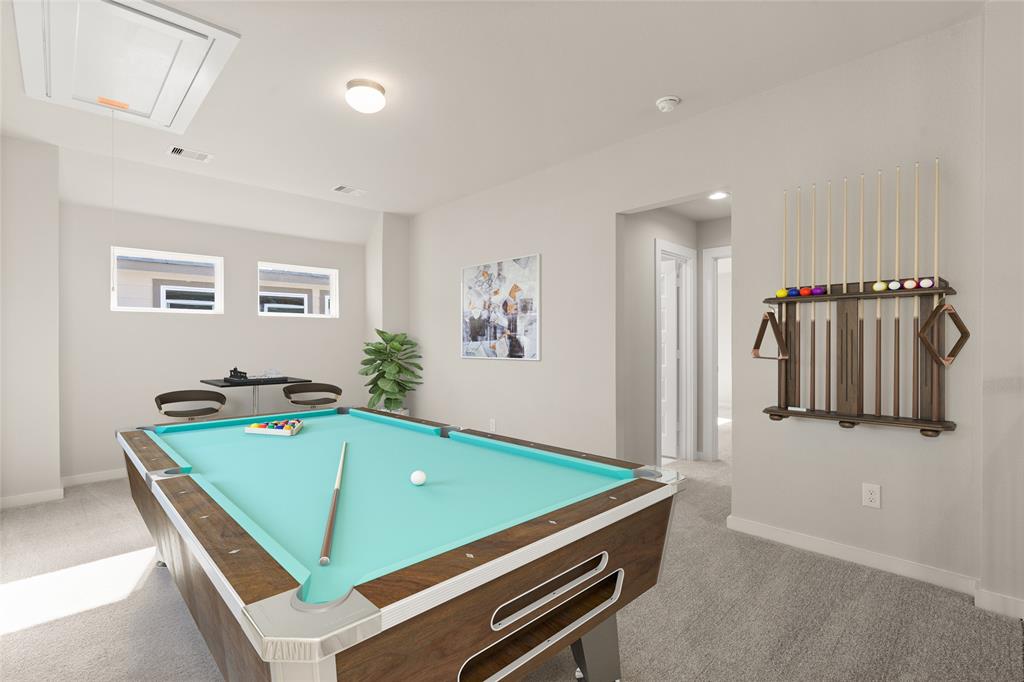 Come upstairs and enjoy a day of leisure in this fabulous game room! This is the perfect hangout spot or adult game room, this space features plush carpet, high ceiling, recessed lighting and custom paint.