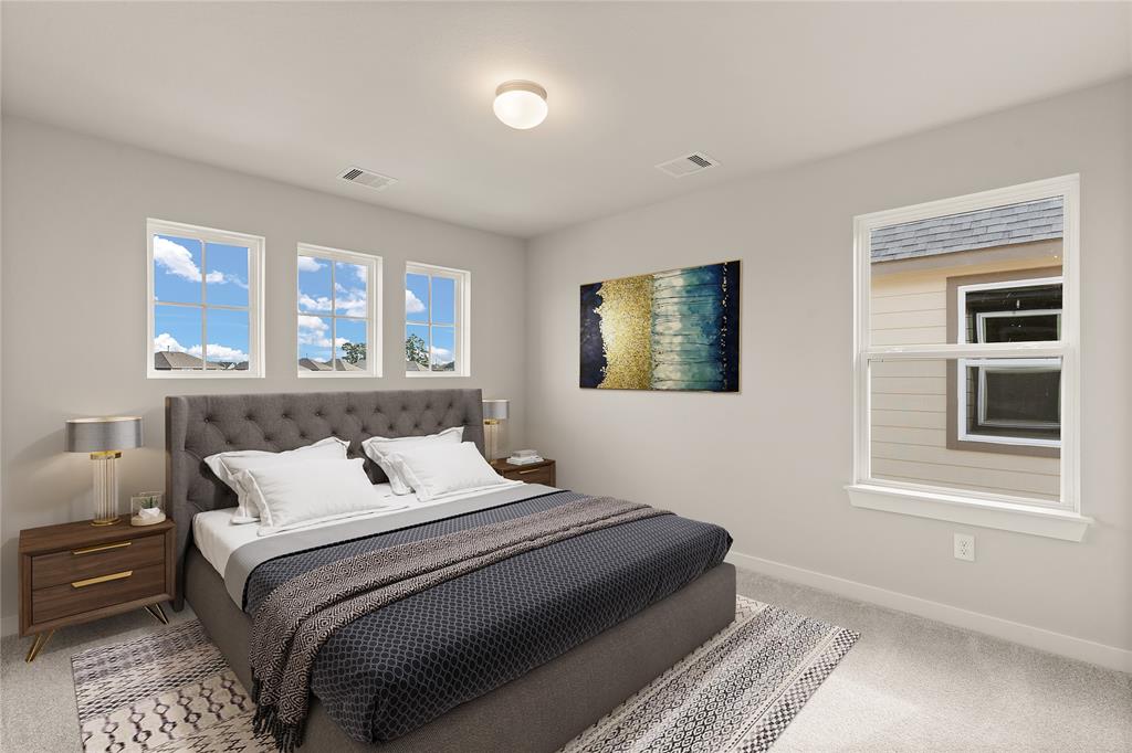 Secondary bedroom features plush carpet, custom paint and large windows.