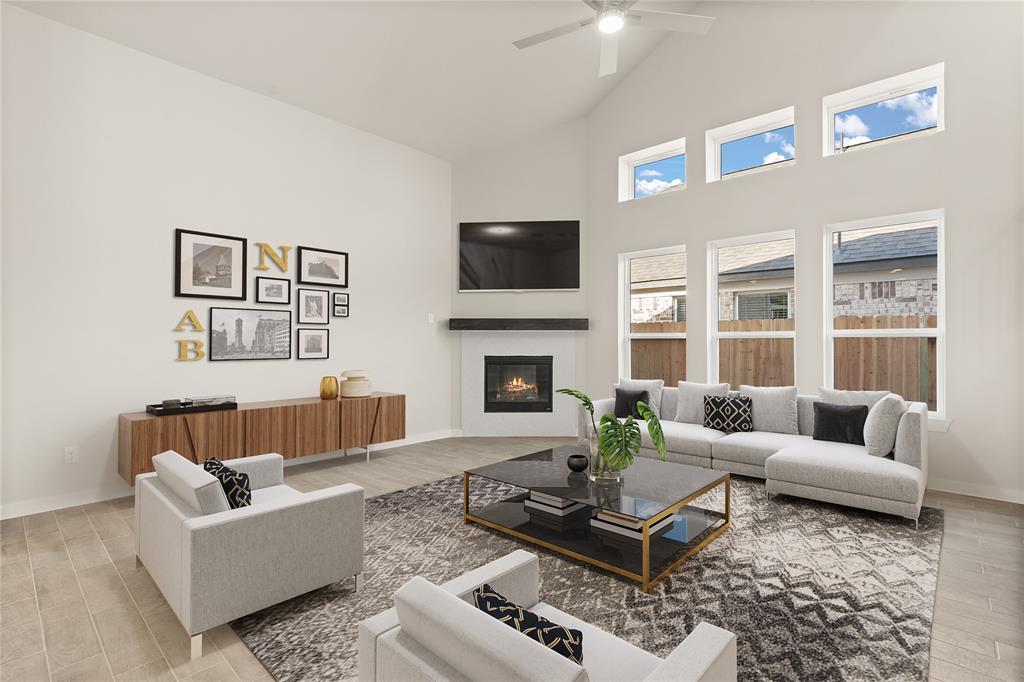 Gather the family and guests together in your lovely living room! Featuring soaring high ceilings, recessed lighting, ceiling fan, custom paint, gorgeous floors, fireplace with mantel and large windows that provide plenty of natural lighting throughout the day.