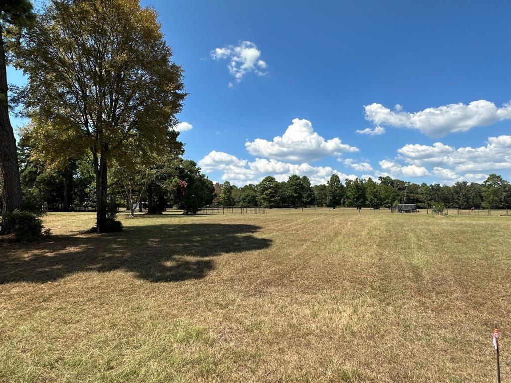 If you are looking for 7 beautiful acres the search is over. This wonderful property is in a lakefront community and already has power, water, and sewer onsite. The back 6 acres are fenced and features a 4 stall barn with a tack room. The front acre has a circle drive that leads up to a 2 car garage with a large storage building on site.        Come build your dream home or bring a mobile home. All measurements should be verified by purchaser. (the mobile home on the property will be removed) Livestock welcome!!