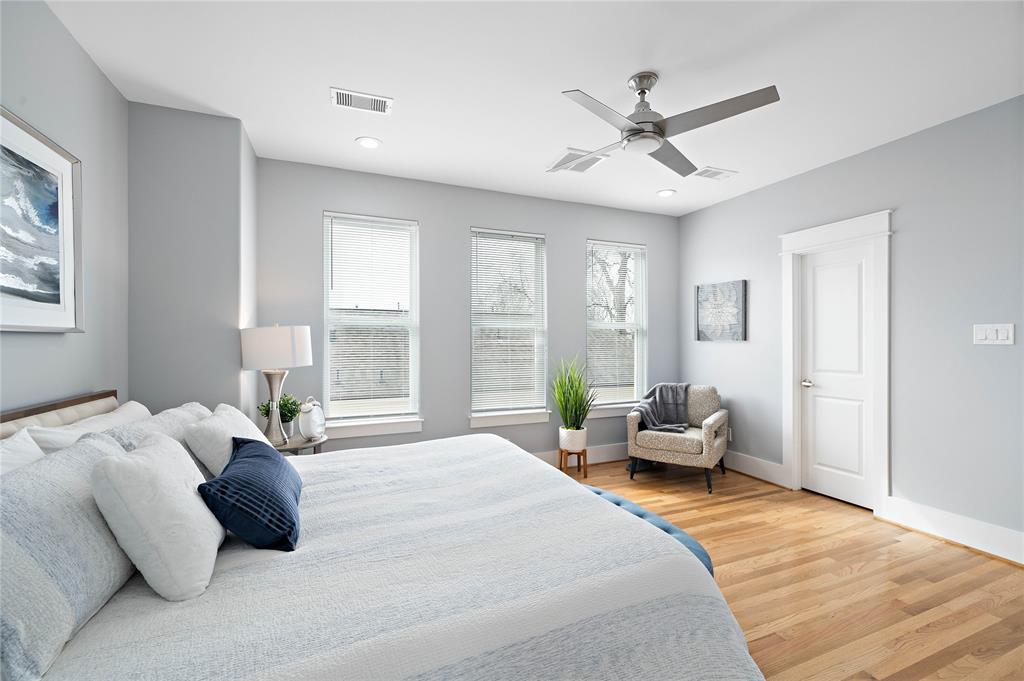 Unwind in the primary suite showcasing hardwood floors, a lavish ensuite bath, a walk-in closet, and double-pane windows that let in copious amounts of natural light.
