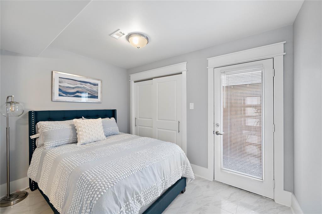 Ideally situated on the first floor, this secondary bedroom offers a large walk-in closet, an ensuite bath, and a stylish full-lite wood door that opens to the backyard.