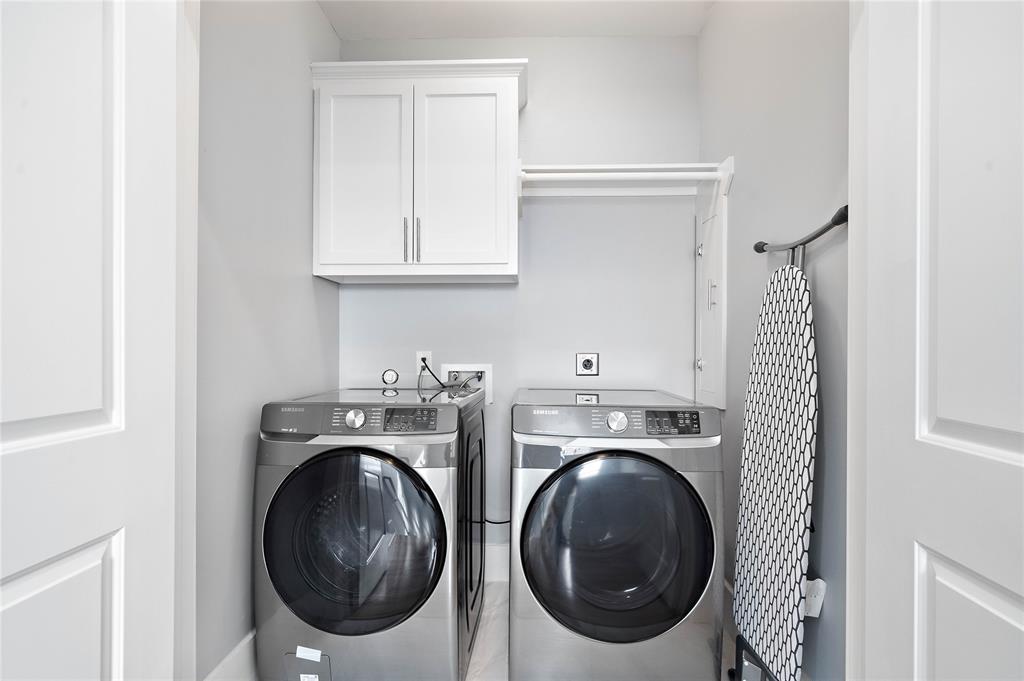 The property is complete with a utility room offering built-in hanging racks, an overhead cabinet, plus a Samsung washer and dryer!