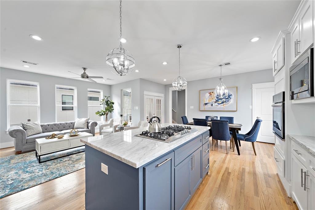 Prepare sumptuous meals in the open kitchen boasting a 5-burner gas cooktop and bar seating, plenty of counter space, plus a convenient layout flowing to the living and dining areas—designed for ease of entertaining!