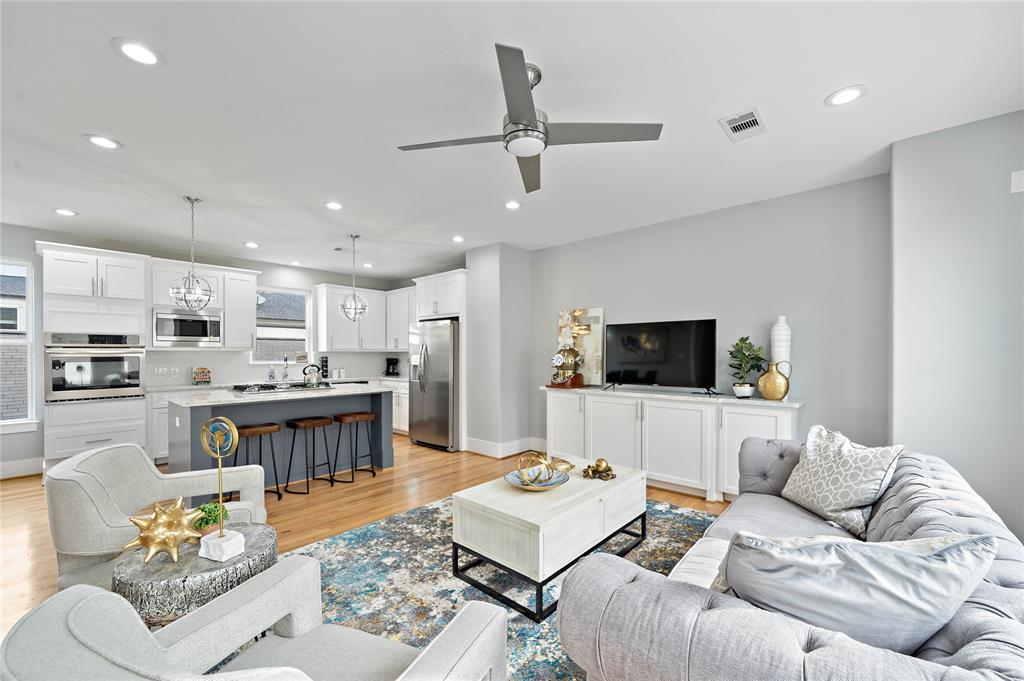 Leave guests in awe as they gather in the bright and spacious living area features timeless hardwood floors, an open layout, recessed lighting, and generous seating options that extend to the eat-in kitchen.