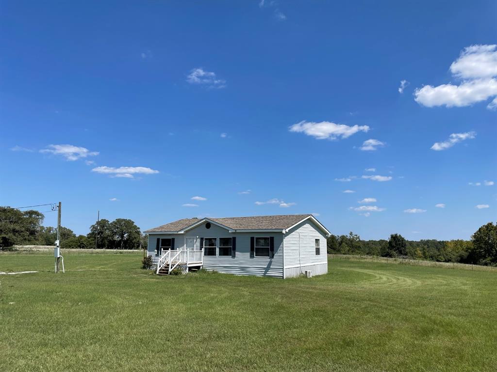 A Little Slice of Texas Heaven! Quaint 3B2B DWMH near the end of the road on 12.49+-ac. All but 2ac is AG Exempt! Just minutes from I-45 in Buffalo, TX. Boasts nice deck off the back and a new ductless AC. Primary has double sinks, separate shower, soaker tub and walk-in closet. The property is partially fenced and cross fenced. Enjoy amazing combo of level, soft sloping terrain, a couple of deep ravines and a wet-weather creek that partially flanks 2 outer boundaries. A nice mix of mature oaks, cedar and other species make up the wooded area, with meandering trails, while the remaining property is cleared with scattered trees. Easy access to I-45, halfway between Houston and Dallas and nearly centrally located in the triangle of Palestine, Waco and Bryan College station. Close by all amenities including Leon County Expo Center that hosts weekly events. Retro-fit report available. A new survey required. All information deemed reliable, buyer and agent to verify.
