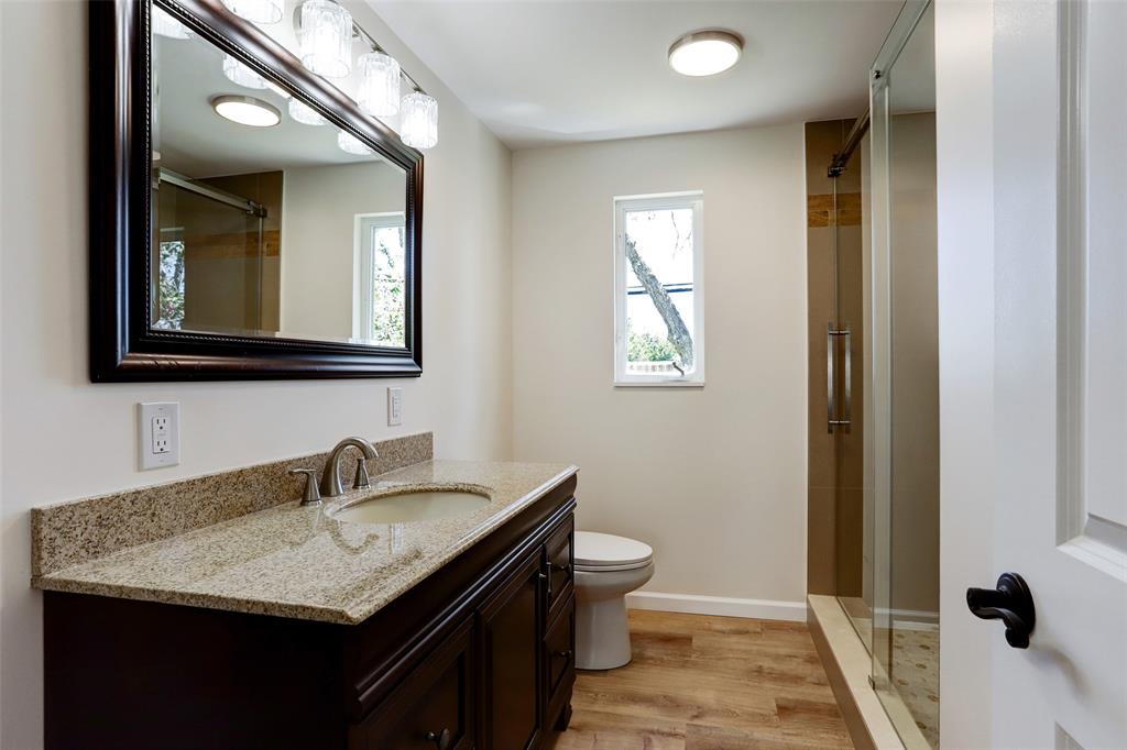 Guest bathroom with large shower and glass doors.