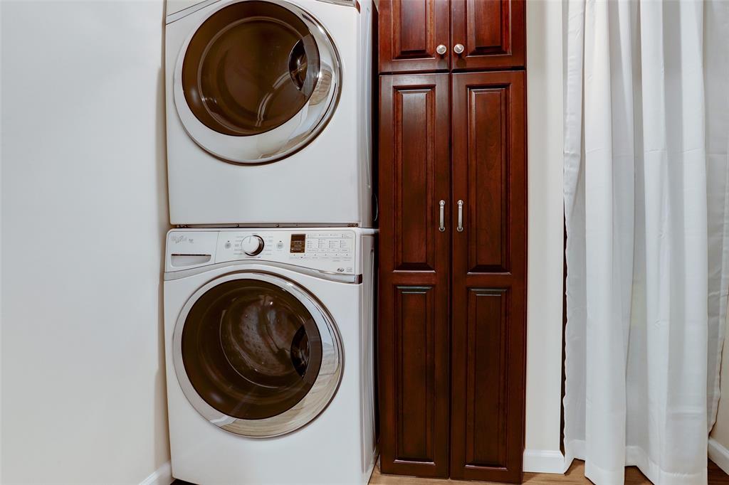 Washer & dryer (included) with storage in the indoor utility room.