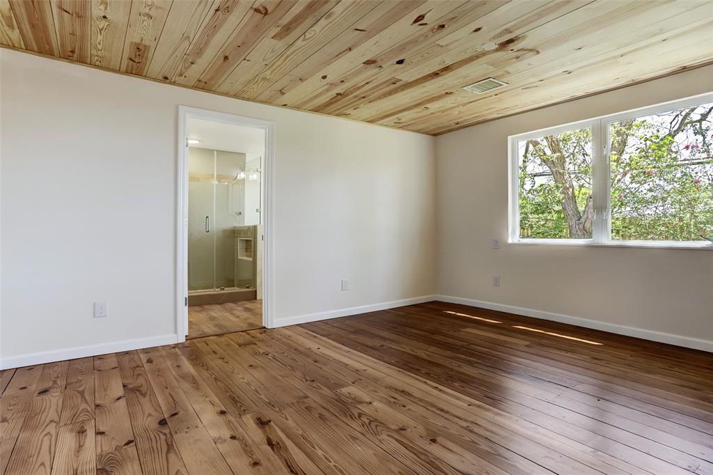 Primary bedroom has extra lighting features for side of bed and mounted television.