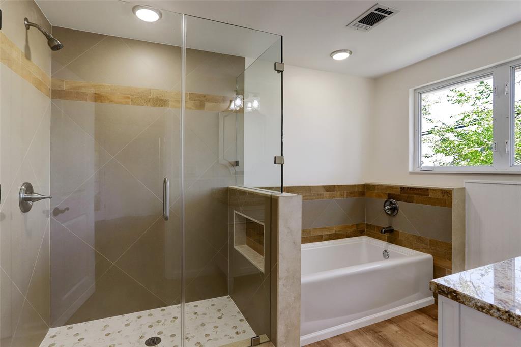 Decorator niche in tile shower with seamless glass enclosure.