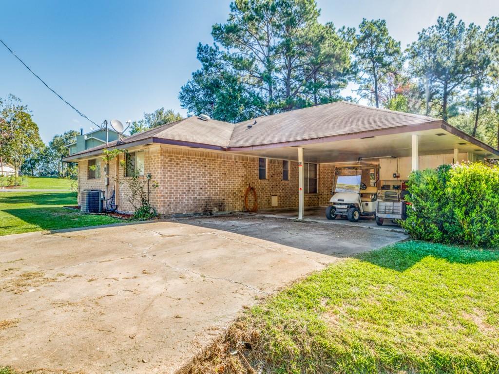 2 car attached carport with outside storage and an attached storage room.