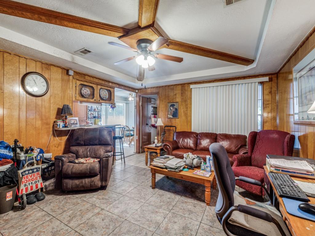 Den has tray ceiling and opens to kitchen/breakfast area