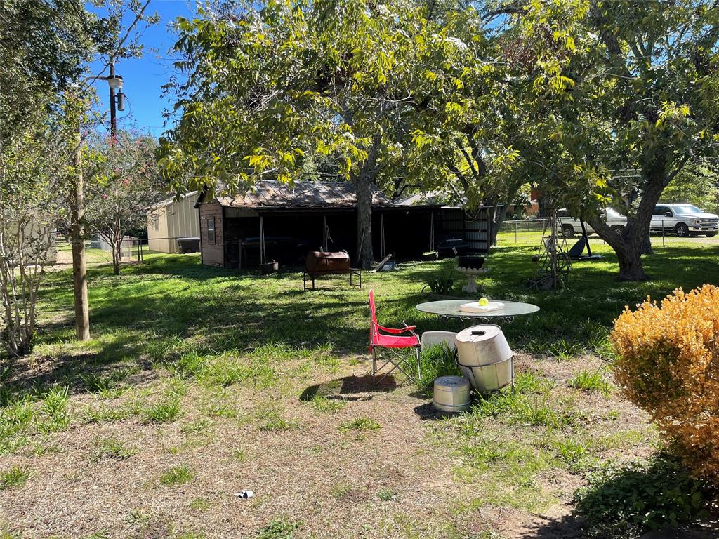 Large backyard - Storage Shed, Covered/storage/work area, and two additional Carports