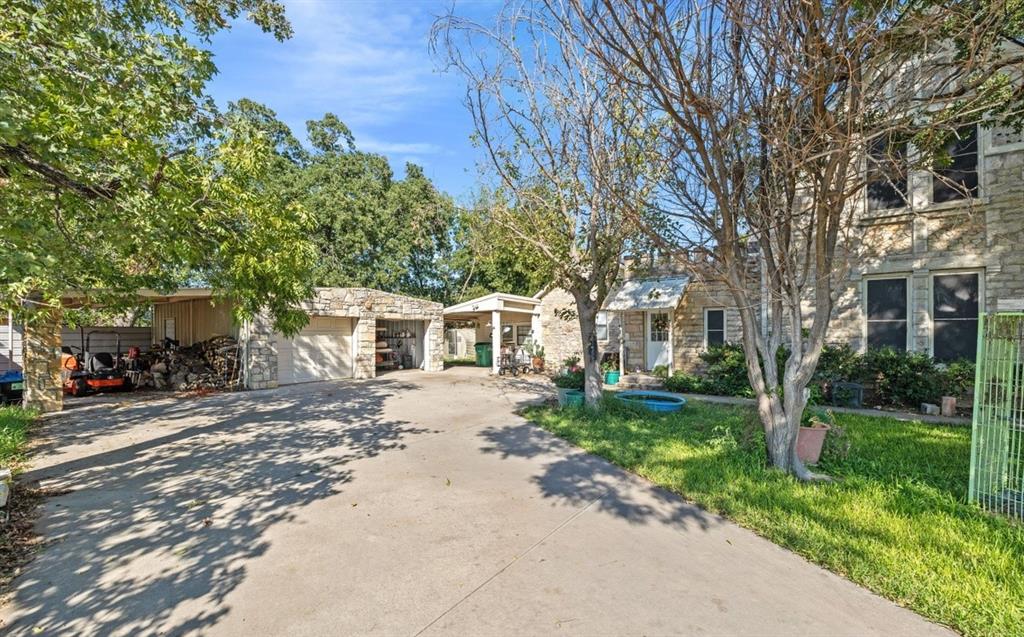 To the left of the house is a detached two car stone garage. There is a total of five covered parking spaces.