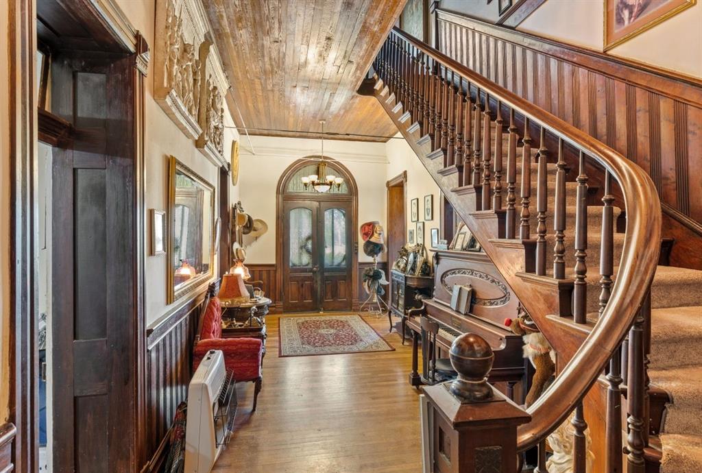 Here is the Wow factor, Charming Foyer with original wood staircase.