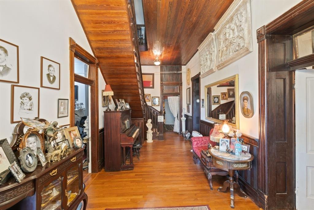 Enter a different time when you walk into this elegant entry with curved wood staircase, and original wood ceilings.