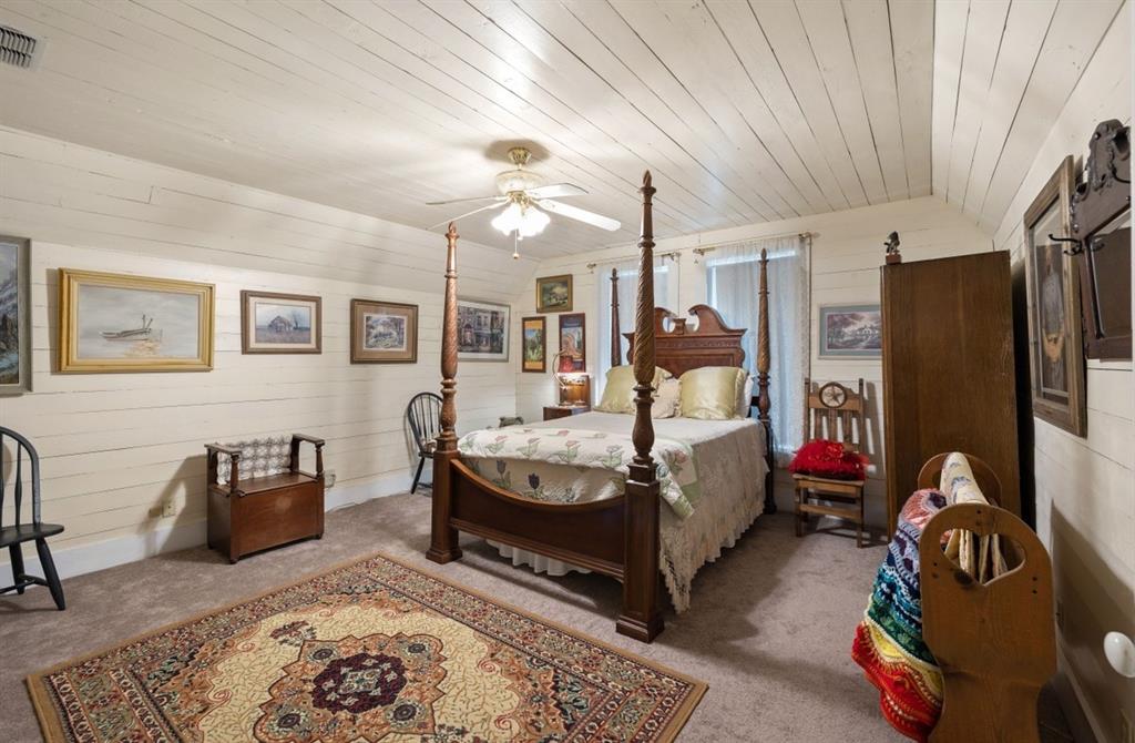 With its own style this upstairs bedroom has painted original walls and ceiling.